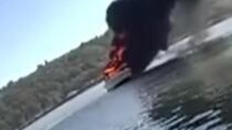 People and cat rescued after boat catches fire