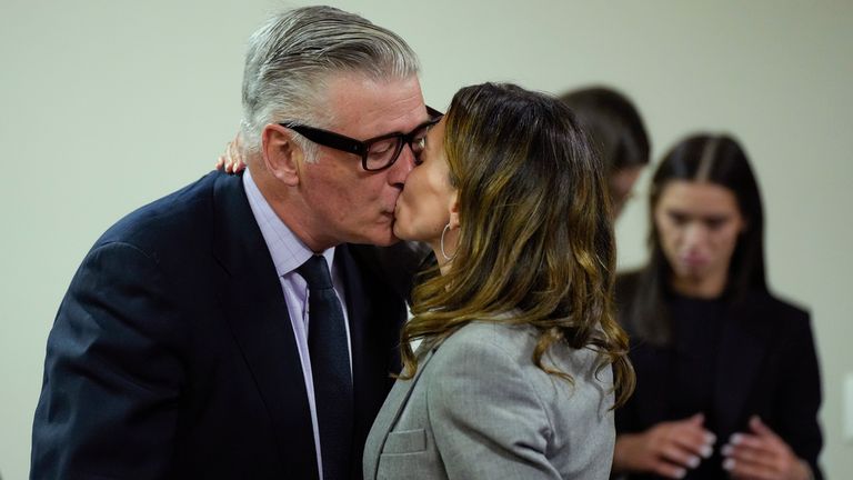 Hilaria Baldwin kisses her husband, actor Alec Baldwin, during his trial for involuntary manslaughter for the 2021 fatal shooting of cinematographer Halyna Hutchins during filming of the Western movie "Rust," Friday, July 12, 2024, at Santa Fe County District Court in Santa Fe, N.M. (Ramsay de Give/Pool Photo via AP)