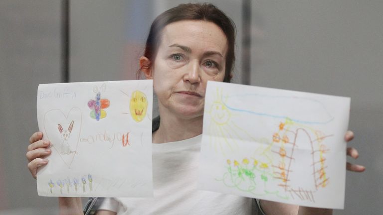 Alsu Kurmasheva holds up drawings from her supporters in court on 31 May. Pic: Reuters