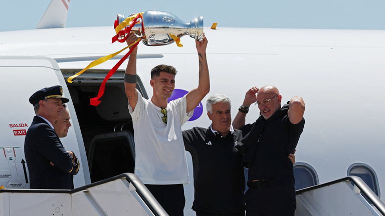 Spain's Alvaro Morata poses with the trophy after arriving in Madrid.
Pic Reuters