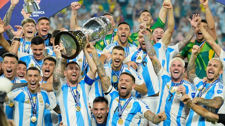 Argentine Lionel Messi holds the trophy as he celebrates with his teammates after defeating Colombia in the Copa America final in Miami Gardens, Florida, Monday, July 15, 2024. (AP Photo/Rebecca Blackwell)