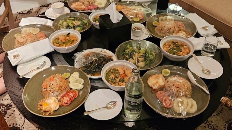 In this photo released by the Royal Thai Police, uneaten meals are left on a table in a room in the Grand Hyatt Erawan Hotel room where six people were found dead from unknown causes, Tuesday, July 16, 2024. Police said the dead in a rooms at Bangkok's Grand Hyatt Hotel were two Vietnamese Americans and four Vietnamese nationals, and speculated they might have died from some kind of poisoning. (Royal Thai Police via AP)