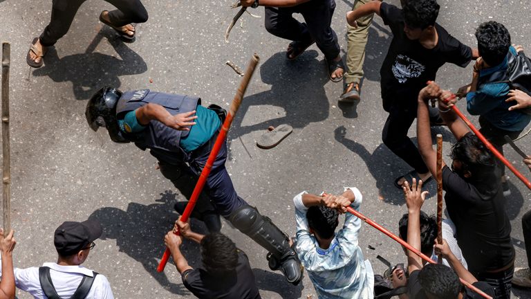 A police officer is surrounded during a clash between anti-quota supporters, police and Awami League supporters at the Rampura area in Dhaka, Bangladesh.
Pic: Reuters