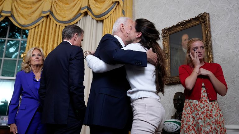 Mr Biden hugs family after addressing the nation from the Oval Office. Pic: AP 