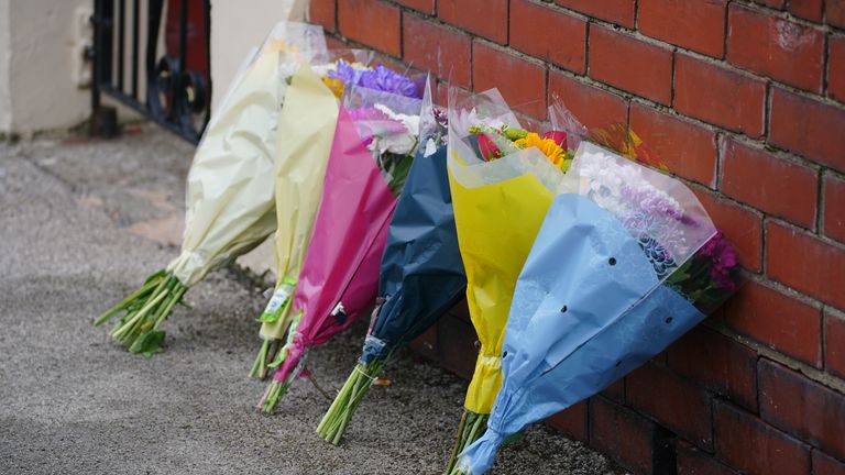 Tributes left at the scene of the fire. Pic: PA