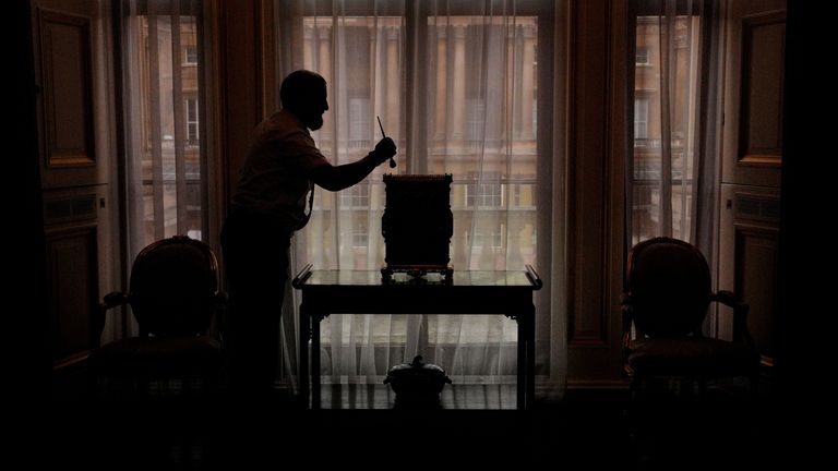 Final preparations are made in the Principal Corridor, where a member of Royal Collection Trust staff tends to a brass work cabinet, in the East Wing of Buckingham Palace, London, which is being opened to visitors for the first time this summer, when special guided tours of the Principal Floor will be available to visitors in July and August. Picture date: Monday July 8, 2024.