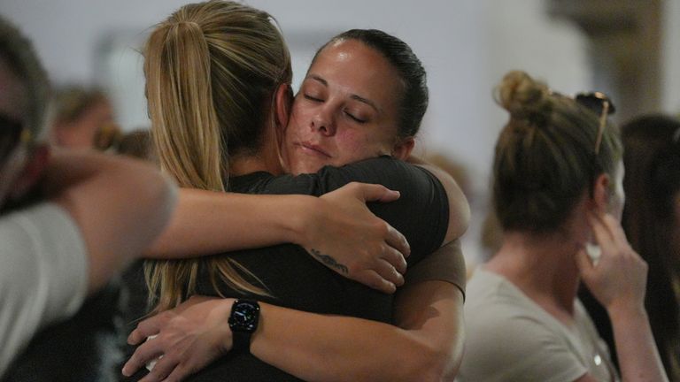 Locals hug one another at Bushey's St James's church on Thursday. Pic: PA