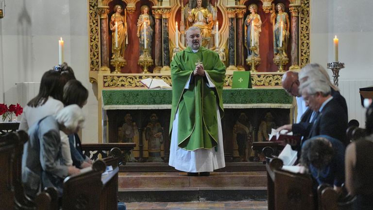 Father Stevenson offers prayers for the victims' family at his morning service at St James's church in Bushey on Thursday. Pic: PA