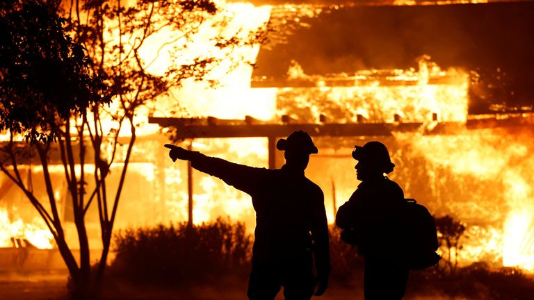 A firefighter gestures as Park Fire burns near Chico, California.
Pic: Reuters