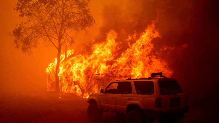 A building burns as the Park Fire tears through a community in Butte County. Pic: AP