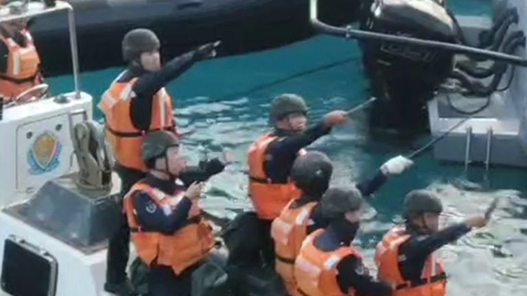 Chinese Coast Guard hold knives and machetes as they approach Philippine troops on a resupply mission in the Second Thomas Shoal. Pic: AP