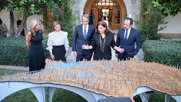 Cyprus President Nikos Christodoulides with his wife and Greek Prime Minister Kyriakos Mitsotakis and his wife look at an artwork on the 50th anniversary of the conflict. Pic: Reuters