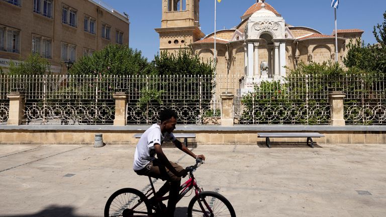 A man rides his bicycle outside the Panagia Faneromeni church in Nicosia, Cyprus June 20, 2024. REUTERS/Yiannis Kourtoglou
