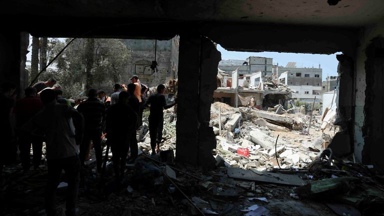 Palestinians inspect a school sheltering displaced people following an Israeli strike in Deir al Balah in central Gaza. Pic: Reuters