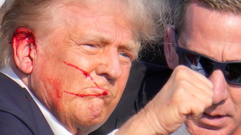 Donald Trump gestures while surrounded by U.S. Secret Service agents.
Pic: AP