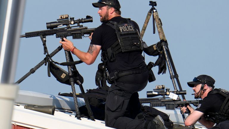 Police snipers return fire after shots were fired while Republican presidential candidate former President Donald Trump was speaking at a campaign event in Butler, Pa., on Saturday, July 13, 2024. (AP Photo/Gene J. Puskar)