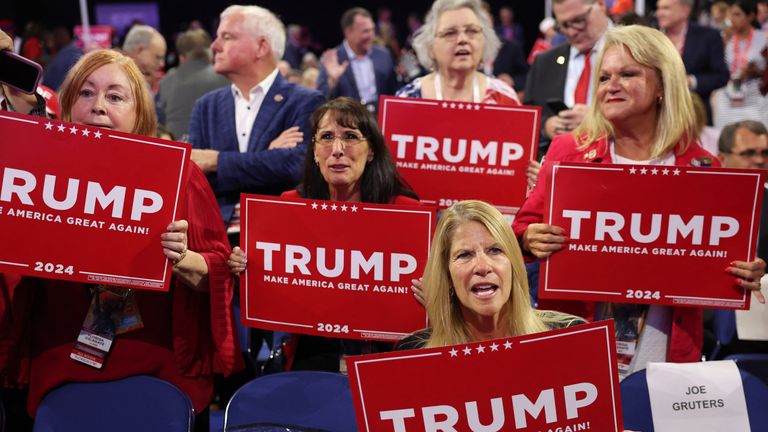 Supporters hold signs for Donald Trump. Pic: Reuters