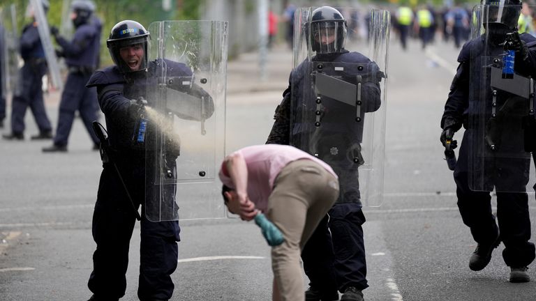 Officers use pepper spray after violent protests outside a site designated to house asylum seekers in Dublin. Pic: PA