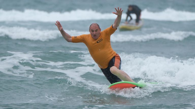 Sir Ed surfing in Cornwall during the election campaign. Pic: PA