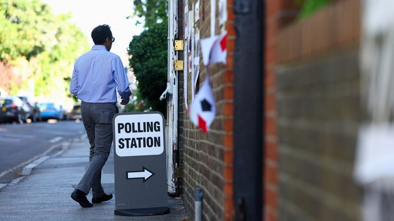 A man walks by a polling station during the general election in London. Pic: Reuters