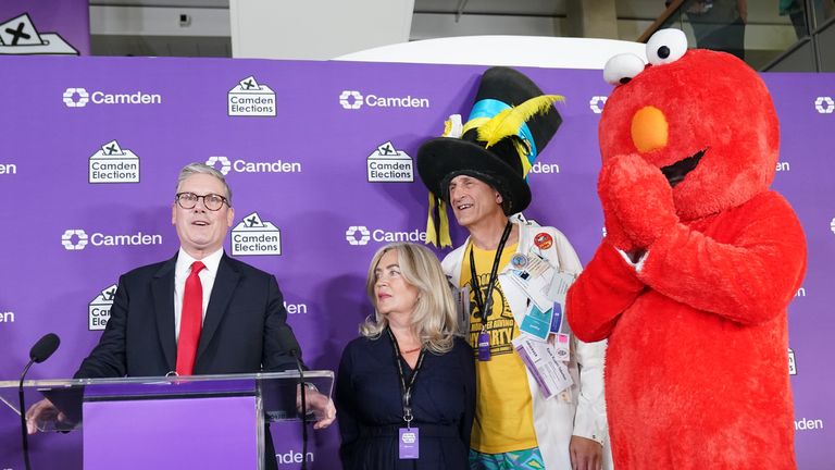 Labour leader Sir Keir Starmer (left) gives a victory speech watched by Nick the Incredible Flying Brick (second right) and Bobby "Elmo" Smith (right) at the headquarters of Camden Council at 5 Pancras Square in Camden, north London, after he was declared winner of the Holborn and St Pancras constituency in the 2024 General Election. Picture date: Friday July 5, 2024.
