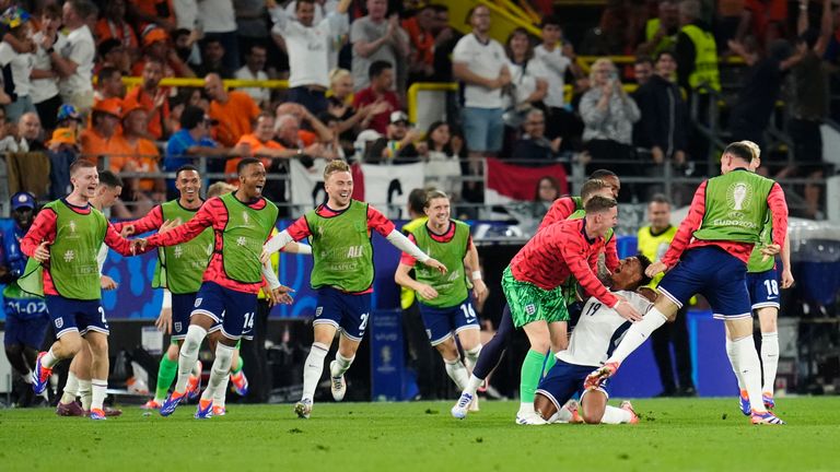 England's substitutes pile on after Ollie Watkins (third right) scores. Pic: PA