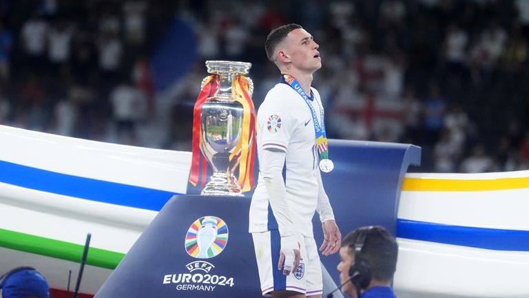 England's Phil Foden overtakes the Henri Delaunay Cup after losing the UEFA Euro 2024 final at the Olympiastadion in Berlin.  Photo date: Sunday, July 14, 2024. PA photo.  See PA Story SOCCER England.  Photo credit should read: Adam Davy/PA Wire...RESTRICTIONS: Use subject to restrictions.  For editorial use only, no commercial use without prior consent of the rights holder.