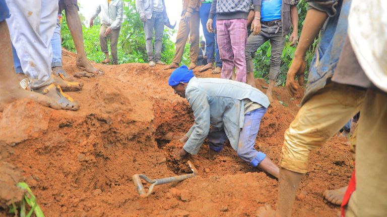 A man searches for survivors. Pic: Gofa Zone Government Communication Affairs Department /AP