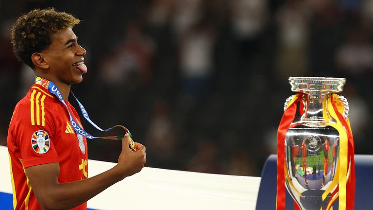 17-year-old Lamine Yamal walks past the trophy after collecting his winners medal. Pic: Reuters