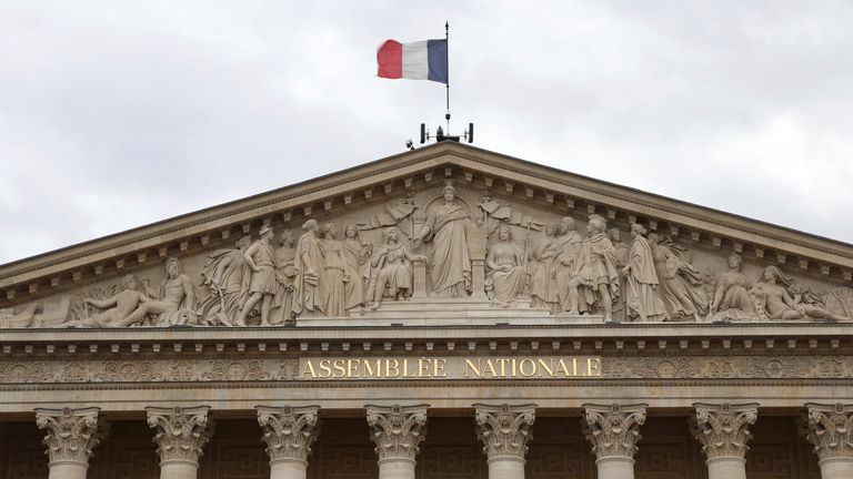 The French flag flies above the National Assembly. Pic: AP Photo/Aurelien Morissard