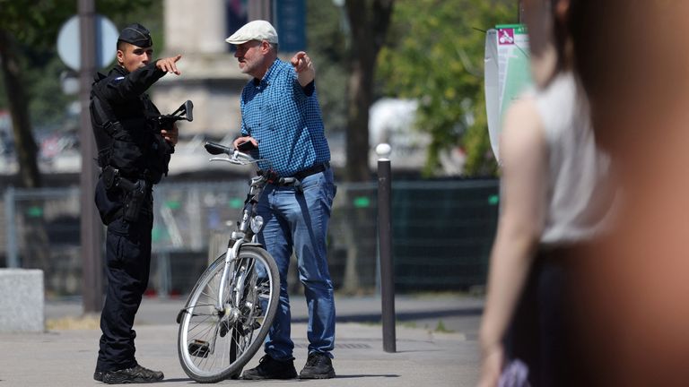 A French police officer talks to a man as the security perimeter for the opening ceremony is deployed near the National Assembly ahead of the Paris 2024 Olympics and Paralympics Games in Paris.
Pic: Reuters