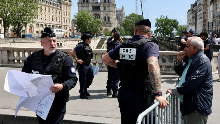 French gendarme prevent people from crossing the Ile de la Cite near Notre Dame Cathedral as the security perimeter for the opening ceremony is deployed ahead of the Paris 2024 Olympics and Paralympics Games in Paris, France
Pic: Reuters