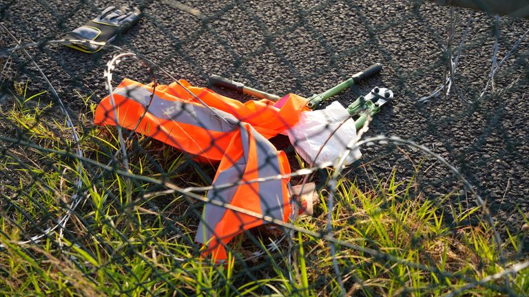 Tools lay on the ground after activists of the "Letzte Generation" (Last Generation) cut a hole in a fence and staged a demonstration near the runways at the airport in Frankfurt, Germany July 25, 2024. REUTERS/Maximilian Schwarz