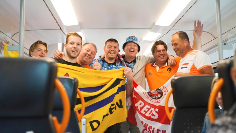 Netherlands and England fans celebrate together. Pic: AP