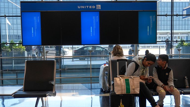 Blue screens showing error messages are displayed instead of flight information at Chicago O'Hare International Airport after a software glitch caused widespread outages as reported by airlines around the world, Friday, July 19, 2024, in Chicago. (AP Photo/Erin Hooley)