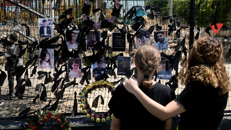 Mourners visit a makeshift memorial for 12 children killed in the strike. Pic: AP