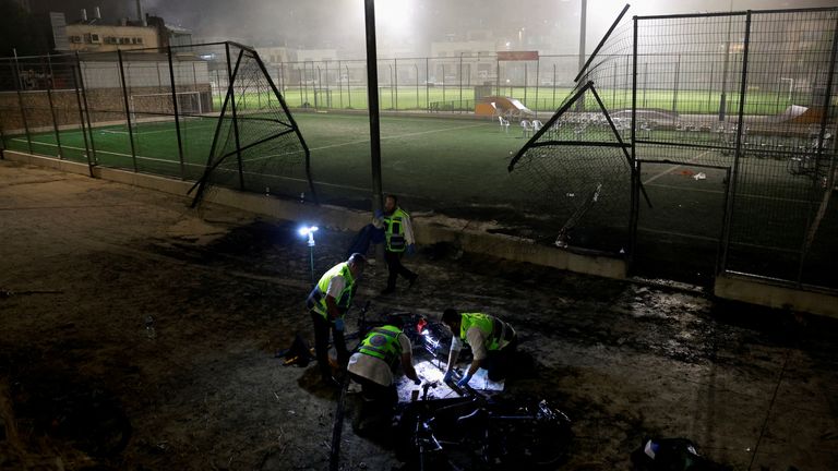 Emergency personnel inspect the area attacked in the Golan Heights. Pic: Reuters