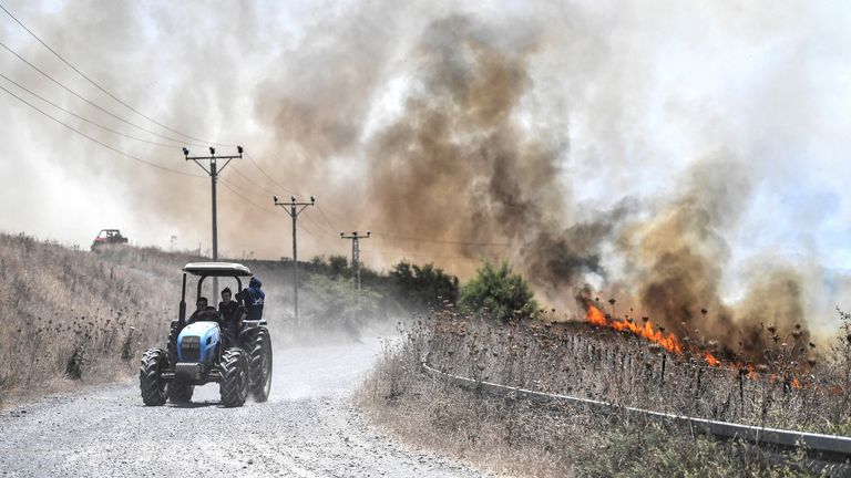 Fires near a road after Lebanon's Hezbollah said it launched more than 200 rockets and a swarm of drones at Israeli military sites, in the Israeli-occupied Golan Heights.
Pic:Reuters