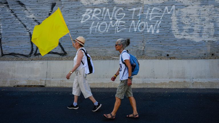 Families and friends of hostages held by Hamas in Gaza call for their return as they begin a four-day march from Tel Aviv to the Prime Minister's house in Jerusalem. Pic: AP Photo/Ohad Zwigenberg