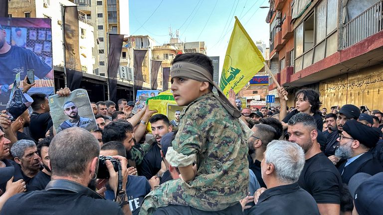 A child on a man's shoulders at a Hezbollah funeral in Beirut, Lebanon