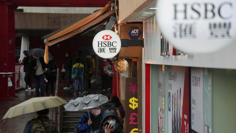 Pedestrians wearing face masks following the outbreak of coronavirus disease (COVID-19) walk past an HSBC bank branch in Hong Kong, China, February 22, 2022. REUTERS/Lam Yik