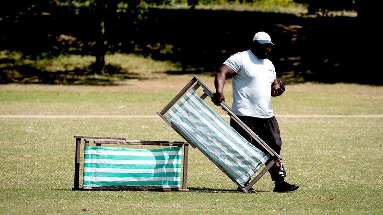 A person holds a deck chair in Hyde Park.
Pic: PA