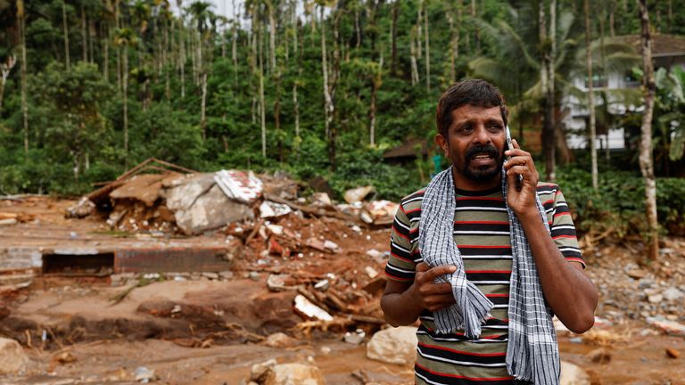 A man cries as he speaks to relatives after his home and auto rickshaw was destroyed after multiple landslides hit the hills in Wayanad district, in the southern state of Kerala, India, July 31, 2024. REUTERS/Francis Mascarenhas