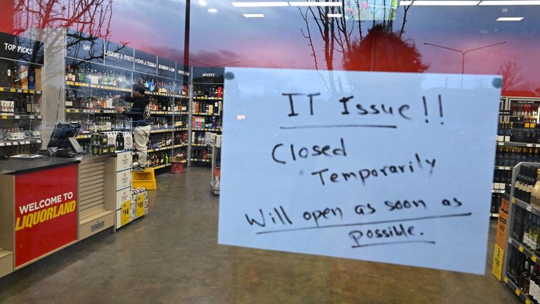 A sign notifies customers of a temporary closure due to IT issues at a Liquorland store in Canberra, Australia, July 19, 2024. AAP Image/Lukas Coch via REUTERS