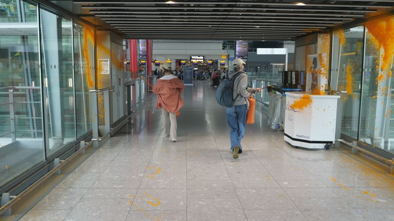 The protesters spray the windows of the corridor leading to T5. Pic: Just Stop Oil
