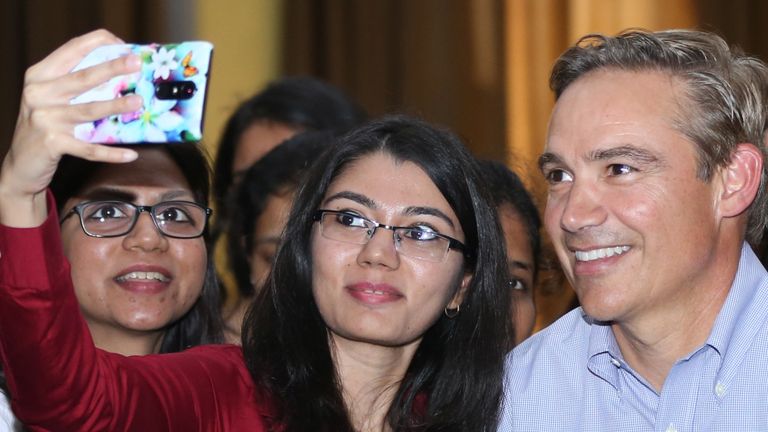 Former Rockwell Collins boss Kelly Ortberg poses for a selfie with company employees in 2017. Pic: AP