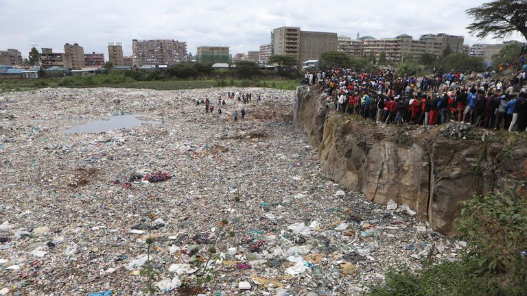 Crowds watch from the edge of a quarry where the remains were discovered. Pic: AP