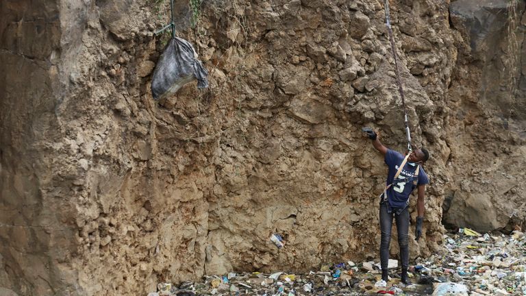 A man is lowered into a quarry where human remains were found in Nairobi. Pic: AP