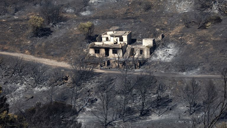 A destroyed home is seen amidst a burnt area after a wildfire at Keratea.
Pic: AP