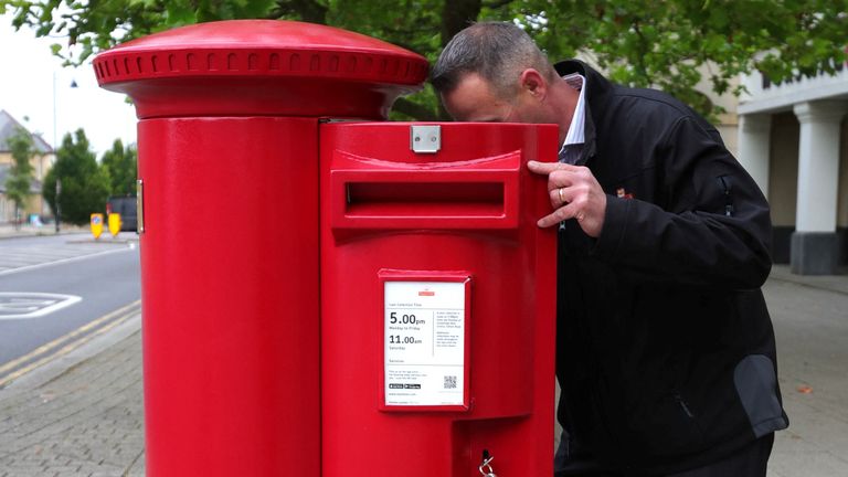 Royal Mail Property and Facilities manager Lee Bromhall inspects the first postbox bearing the cypher of  King Charles.
Pic:Reuters